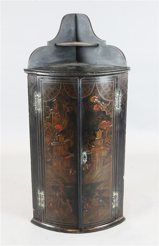 An early 18th century black japanned bowfront hanging corner cupboard, W.2ft H.3ft 11in.